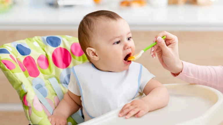 Baby being fed baby food