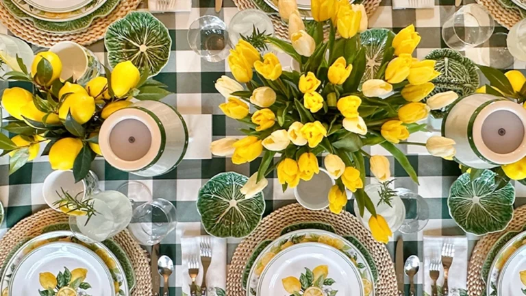 table with plates on it and yellow flowers